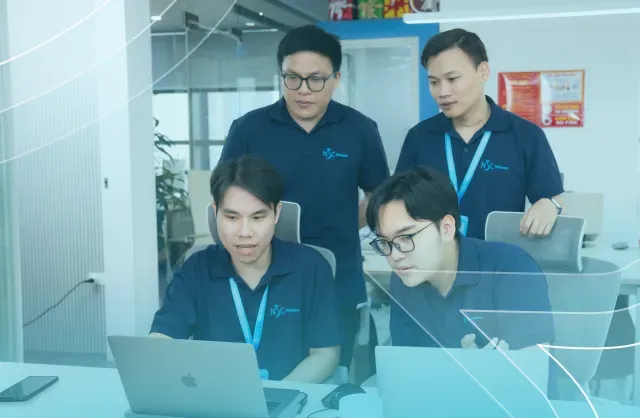 NSC Software team collaborating in a modern office